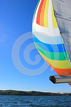 The wind has filled colorful spinnaker sail