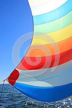 The wind has filled colorful spinnaker sail