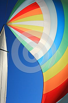 The wind has filled colorful spinnaker sail