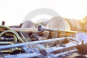 Wind instruments lying on a table against a blurred background.