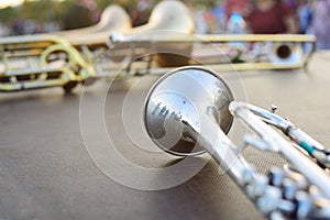Wind instruments lying on a table against a blurred background.