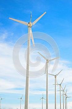 Wind mill power plant against blue sky