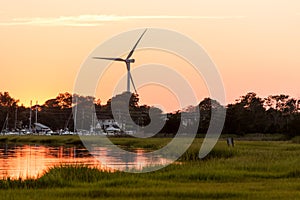 Wind mill turbine sunset by creek