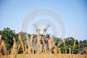 Wind mill. Windmill in a rural area. Wind Farm. Dutch windmill. Landscape with traditional Ukrainian windmills houses in