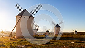 Wind mills at Campo de Criptana in evening sun photo