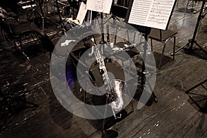 wind musical instruments lie on chairs in the orchestra pit