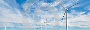 Wind power generator on blue sky background. Renewable energy source. Powerful and ecological energy concept