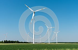 Wind power generators in front of a clear blue sky