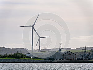 Wind power generators in the Ireland, landscape. Two wind turbines located in Ringaskiddy, County Cork. Cloudy overcast sky. wind