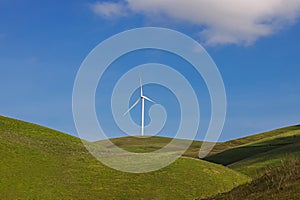 Wind power mill on the green hills