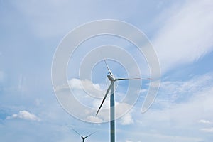 Wind power plant on the background of bright cloudy sky. wind generator close-up. green electricity, alternative energy
