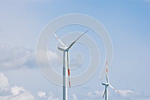 Wind power plant on the background of bright cloudy sky. wind generator close-up. green electricity, alternative energy