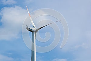 Wind power plant on the background of bright cloudy sky. wind generator close-up. green electricity, alternative energy