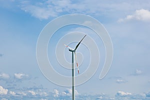 Wind power plant on the background of bright cloudy sky. wind generator close-up. green electricity, alternative energy