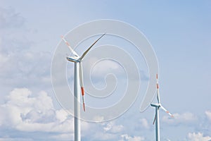 Wind power plant on the background of bright cloudy sky. wind generator close-up. green electricity, alternative energy