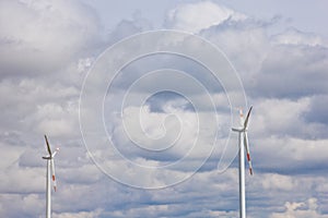 Wind power plant on the background of bright cloudy sky. wind generator close-up. green electricity, alternative energy