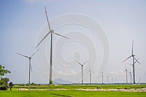 Wind power plant. green meadow with Wind turbines generating electricity