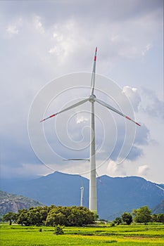 Wind power plant. green meadow with Wind turbines generating electricity