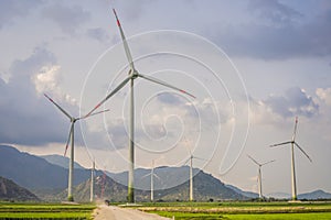 Wind power plant. green meadow with Wind turbines generating electricity