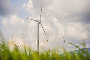 Wind power plant. green meadow with Wind turbines generating electricity