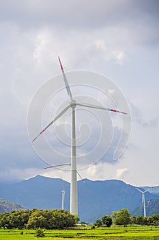 Wind power plant. green meadow with Wind turbines generating electricity