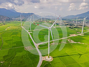 Wind power plant. green meadow with Wind turbines generating electricity