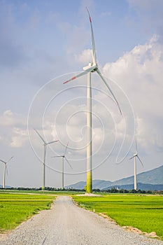 Wind power plant. green meadow with Wind turbines generating electricity