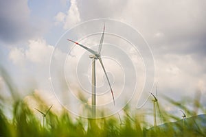 Wind power plant. green meadow with Wind turbines generating electricity