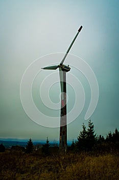 Wind power plant in a massive fog.