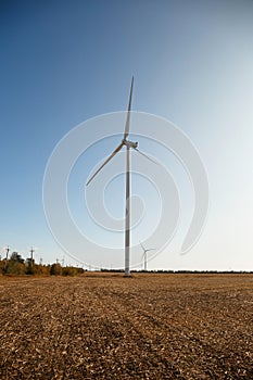 Wind power plant. Windmill in a field to produce electricity from the wind. Green energy concept