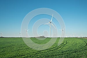 Wind power station on field. Technology and inovation. Green energy composition. Wind turbines.