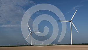 Wind power towers located in a field and producing green energy.