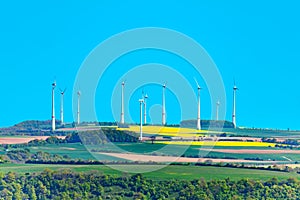 Wind power turbine generators rotate in a field