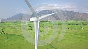 Wind power turbines aerial landscape. Windmill turbine generating clean renewable energy in green agricultural field