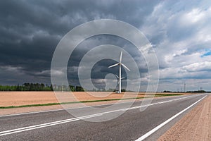 Wind power. Wind power plant. Wind farm Wind generators in a field near the highway. Production of alternative green renewable ene