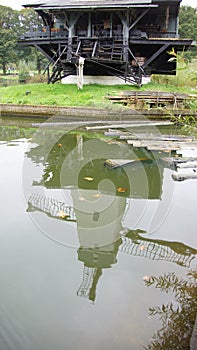 Wind saw mill in reflection in the water