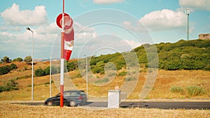 Wind sock fly. Summer hot day on private sporty airport with abandoned windsock, wind is blowing and windsock is lazy