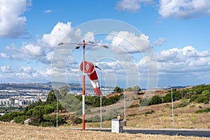 Wind sock fly. Summer hot day on private sporty airport with abandoned windsock, wind is blowing and windsock is lazy moving