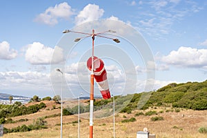 Wind sock fly. Summer hot day on private sporty airport with abandoned windsock, wind is blowing and windsock is lazy moving