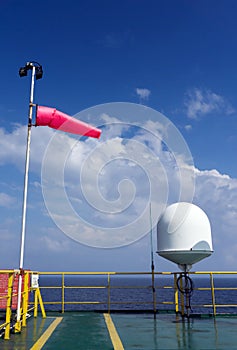 Wind sock on a pole on board a construction work barge at oil field