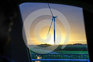Wind tower turbine power plant at sunset