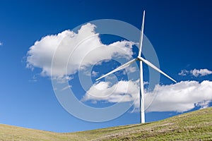 Wind turbine with 3 blades in a field of grass