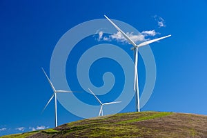 Wind turbine with 3 blades in a field of grass