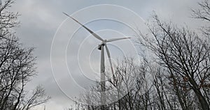 Wind turbine in action in the middle of the woods