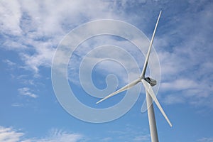 Wind turbine against blue sky. Alternative energy source