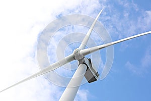 Wind turbine against  blue sky, low angle view. Alternative energy source