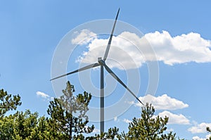 Wind turbine against blue sky on a sunny day