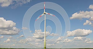 Wind turbine against the blue sky. Wind generator close-up. Rotation of wind turbine blades against the sky.