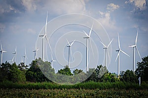 Wind turbine against cloudy blue sky