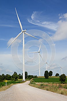 Wind turbine against cloudy blue sky background